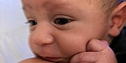 Aries joined the competition — help win amazing prizes! baby, close_up, face, hand, skin, shoulder, infant, person, curious, resting, expression, soft_focus, intimate, cute, newborn, young_child, portrait, human, touch, comfort