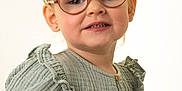 Ambre a rejoint le concours — aidez-le/la à gagner de superbes lots ! child, toddler, glasses, pigtails, green_dress, portrait, smile, cute, fashion, indoor, young_child, person, studio, buttoned_dress, face, happy, eyewear, hair, light_background, sitting