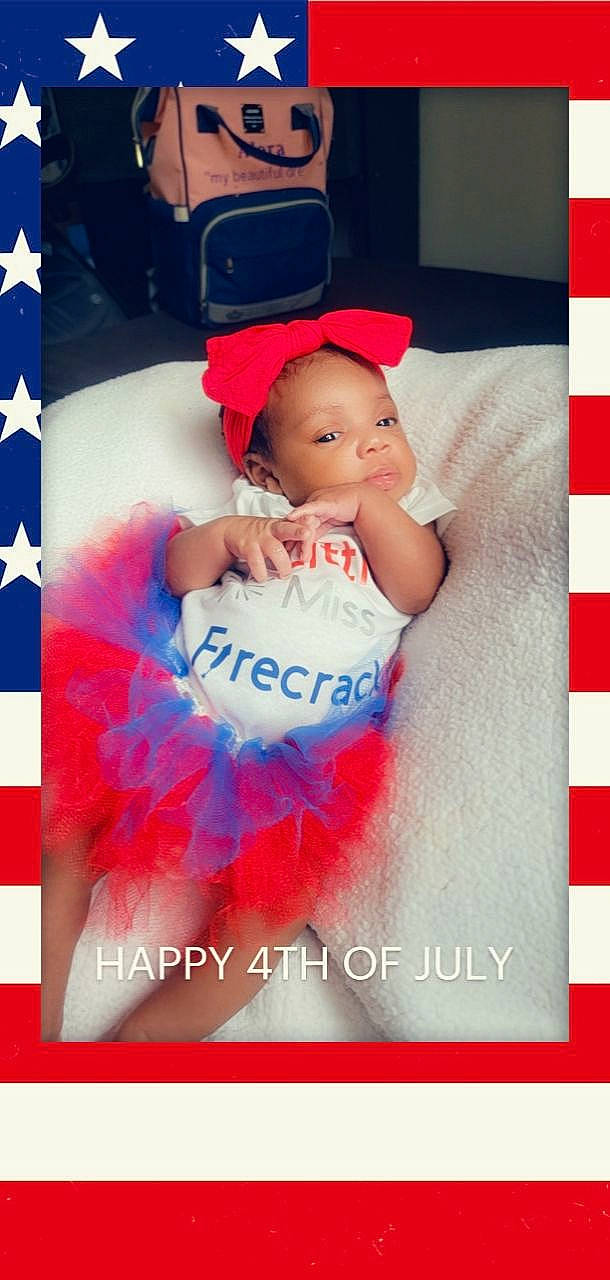 Alora is registered to the contest to win money with this photo: aqua, baby, baby_products, baby_toddler_clothing, electric_blue, event, facial_expression, font, happy, human, magenta, pattern, person, petal, photo_caption, picture_frame, pink, poster, product, textile