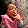 Alaya is registered to the contest to win money with this photo: apparel, baby, child, closeup, cozy, cute, face, fingers, hand, indoors, infant, knitted_blanket, newborn, peaceful, person, pink_bib, portrait, resting, sleeping, soft_lighting