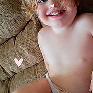 Avery joined the competition — help win amazing prizes! toddler, child, smiling, curly_hair, couch, indoor, happy, face, skin, diaper, playful, heart, doodle, pink, casual, relaxing, portrait, closeup, seat, cute