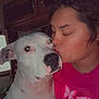 Cassidy Gary joined the competition — help win amazing prizes! person, dog, indoor, kiss, affection, white_dog, pink_shirt, portrait, close_up, cabinet, home, pet, animal, face, nose_ring, black_spots, love, calm, human, companionship