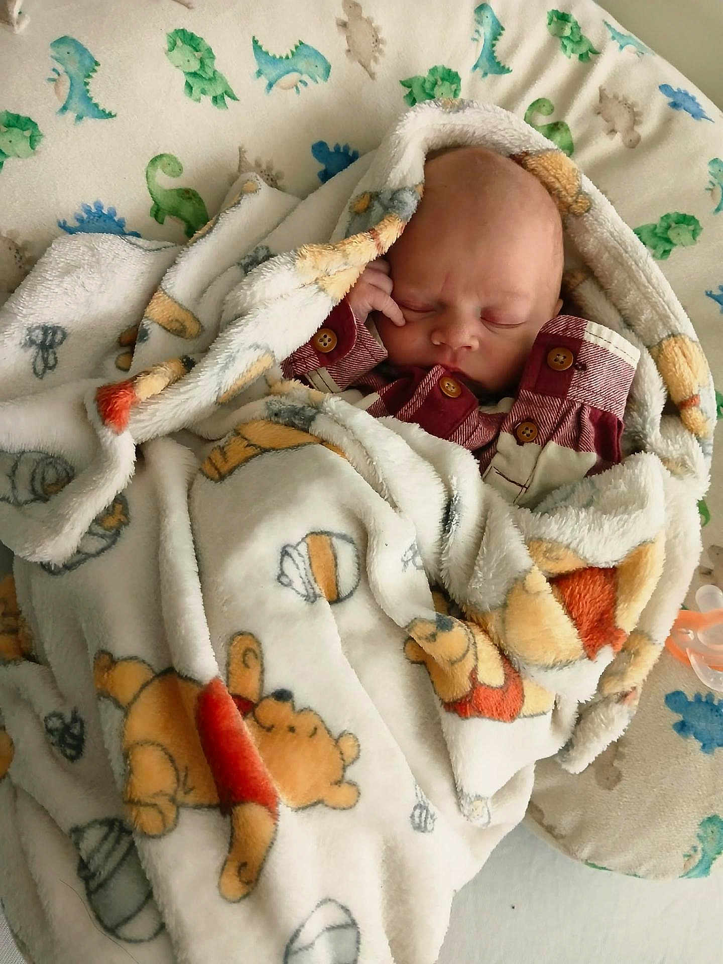 Grayson is registered to the contest to win money with this photo: baby, newborn, infant, sleeping, blanket, swaddle, pajamas, pacifier, nursery, plush, teddy_bear, cartoon_print, pattern, bed, pillow, closeup, peaceful, tiny_hand, button, cozy