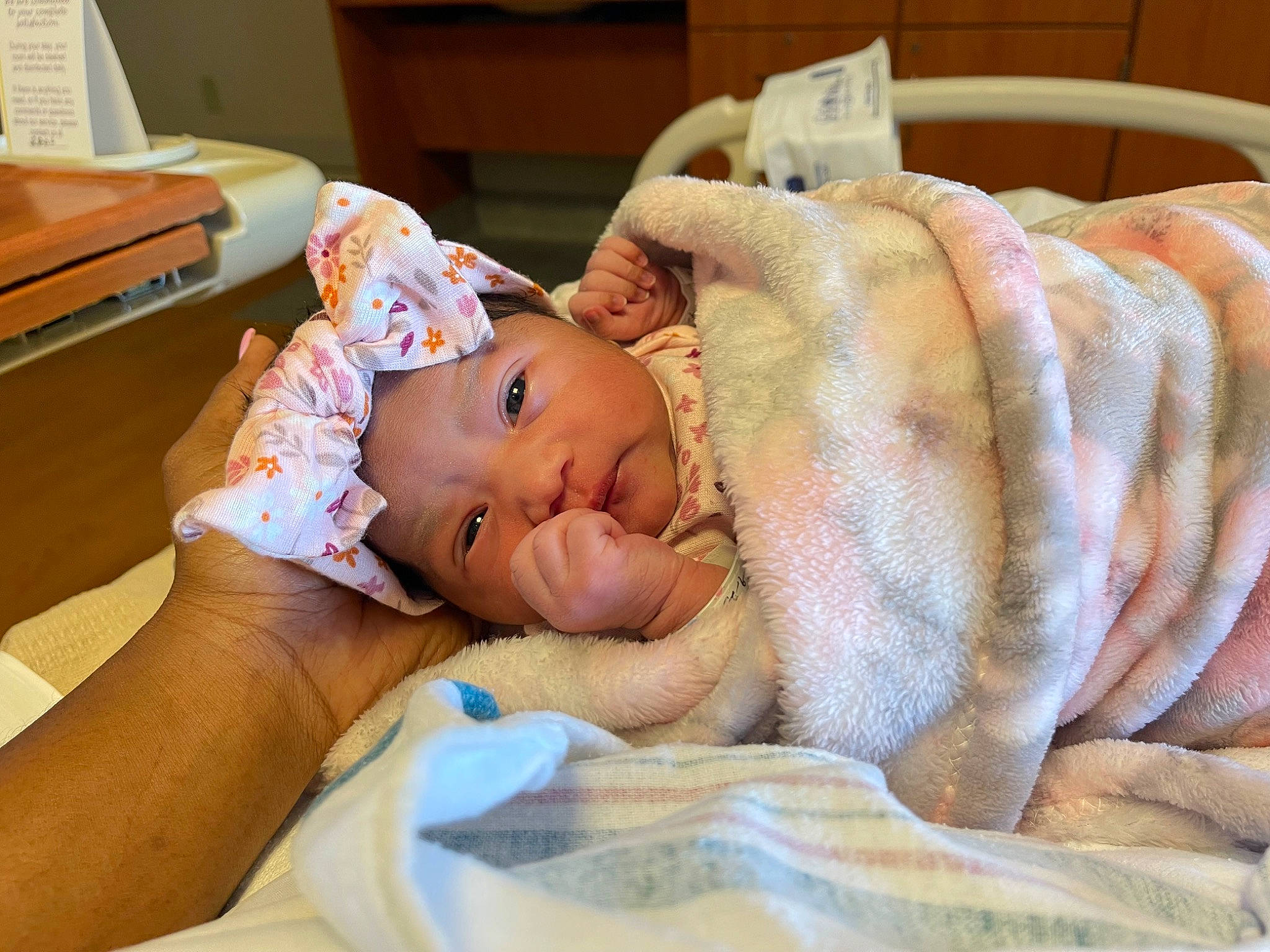 Evangeline is registered to the contest to win money with this photo: baby, baby_toddler_clothing, bedding, bedtime, child, childbirth, comfort, event, fur, hat, headwear, health_care, hospital, linens, medical, patient, person, room, service, skin