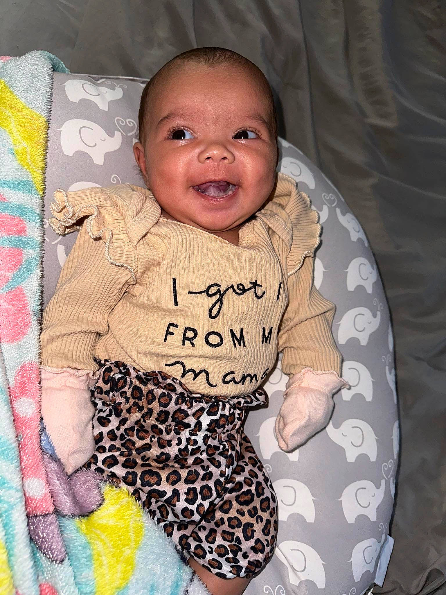 Aspen is registered to the contest to win money with this photo: baby, baby_products, baby_toddler_clothing, cheek, child, comfort, eye, face, happy, iris, linens, outerwear, pattern, person, room, sitting, sleeve, smile, t_shirt, textile