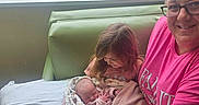 Grace joined the competition — help win amazing prizes! baby, bed, blanket, caring, child, curtain, family, glasses, holding, hospital, indoor, love, newborn, parking_lot, pink_shirt, seated, smile, trees, window, woman