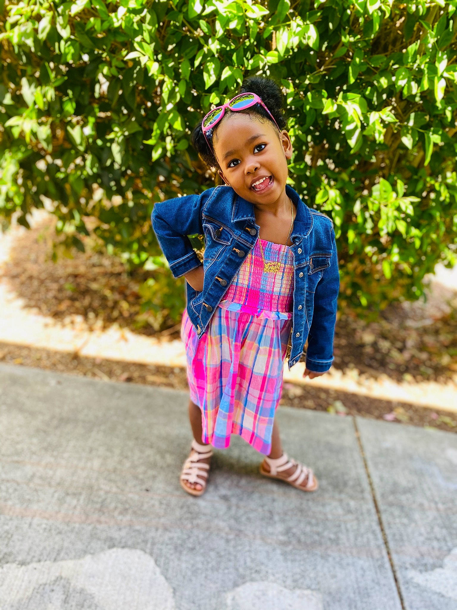 Aniya is registered to the contest to win money with this photo: blue, child, child_model, dress, joy, outerwear, pattern, person, photography, pink, plaid, plant, play, shoe, sleeve, smile, street_fashion, textile, toddler, vacation
