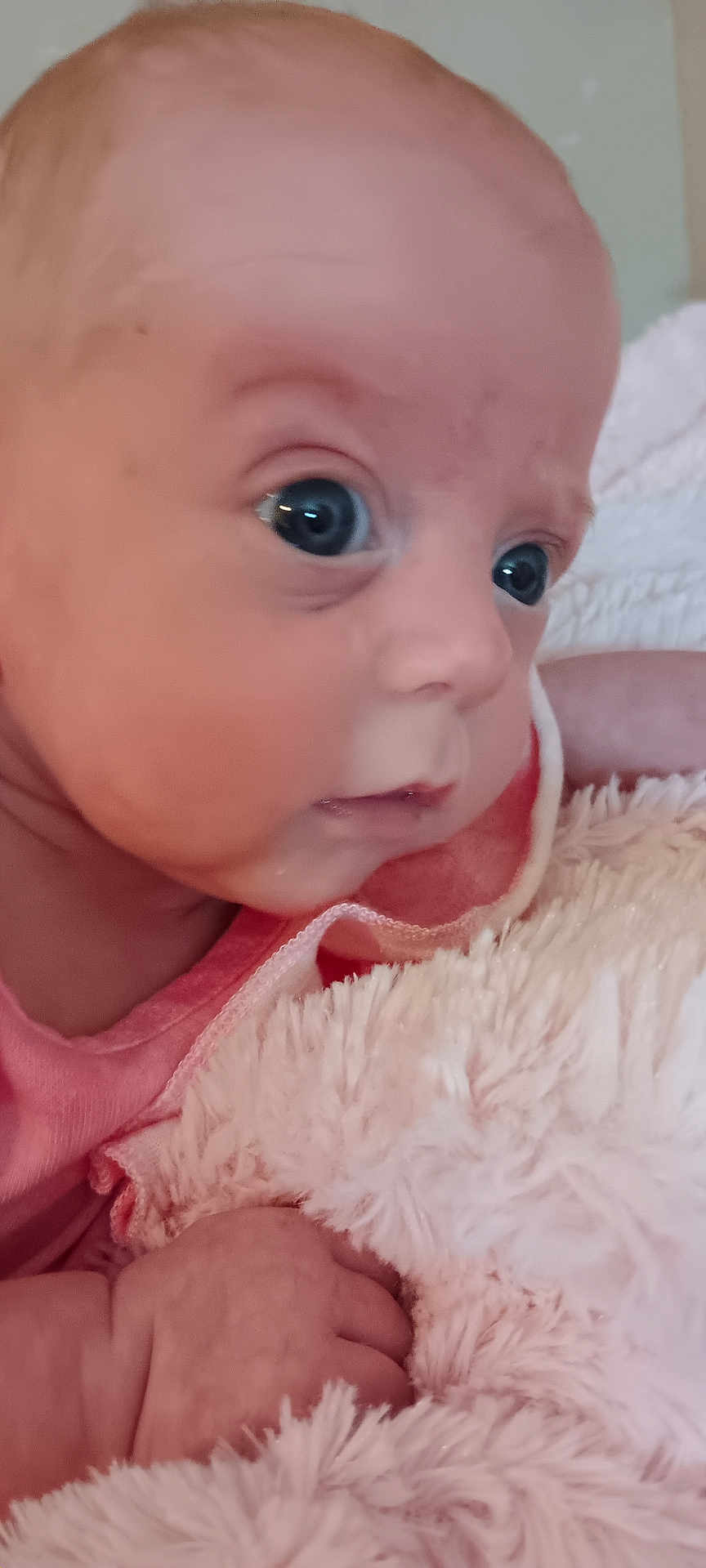Serenity joined the competition — help win amazing prizes! baby, infant, close_up, face, hand, blanket, soft_texture, cute, skin, eyes, pink_clothing, newborn, portrait, indoor, child, expression, curious, young, human, resting