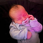 Camden is registered to the contest to win money with this photo: baby, infant, newborn, pacifier, sleeping_baby, onesie, hand, face, close_up, portrait, blanket, bedding, cozy, pink_tint, soft_lighting, tiny_fingers, peaceful, indoor, resting, cute