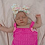 baby, sleeping, pink_dress, headband, bow, blanket, infant, cute, peaceful, rest, child, soft_texture, portrait, adorable, newborn, relaxed, sleep, person, clothing, indoors