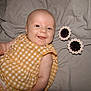 baby, smiling, infant, yellow_dress, gingham, blanket, sunglasses, daisy, flower, cute, happy, lying_down, child, portrait, face, skin, arm, clothing, indoor, soft