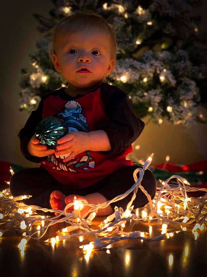 Kannon joined the competition — help win amazing prizes! candle, child, christmas, christmas_decoration, christmas_eve, christmas_lights, christmas_ornament, christmas_tree, event, fir, fun, holiday, interior_design, lighting, ornament, person, plant, sitting, toddler, tradition
