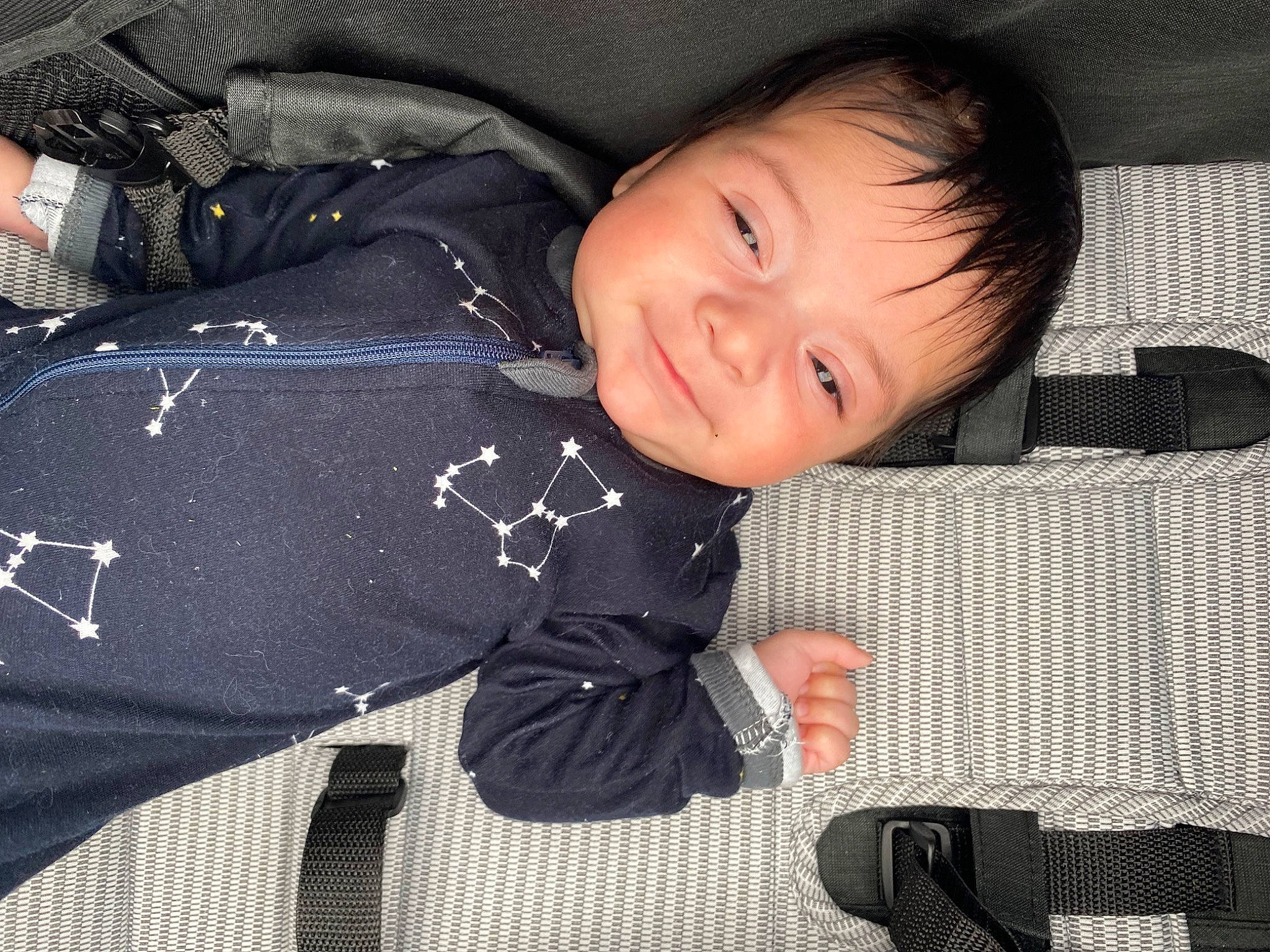 Ezra joined the competition — help win amazing prizes! baby, baby_toddler_clothing, bag, cheek, child, comfort, happy, luggage_and_bags, pattern, person, plaid, sitting, sleeve, smile, textile, toddler, travel