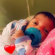 Prince joined the competition — help win amazing prizes! baby, pacifier, blanket, sleepy, infant, red_heart, clothing, face, person, portrait, bed, resting, newborn, cute, soft, wrapped, indoor, closeup, hand, baby_garments