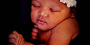 Eastlynn joined the competition — help win amazing prizes! baby, sleeping, flower_headband, newborn, infant, skin, peaceful, closeup, portrait, cute, soft_lighting, arm, hand, face, dark_background, adorable, serene, child, head, resting