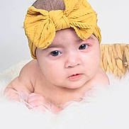 Alaina is registered to the contest to win money with this photo: baby, headband, yellow, bow, basket, fluffy, soft, skin, face, infant, child, portrait, resting, white, hands, cute, closeup, expression, indoor, newborn