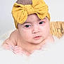 baby, headband, yellow, bow, basket, fluffy, soft, skin, face, infant, child, portrait, resting, white, hands, cute, closeup, expression, indoor, newborn