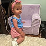 Scarlett Drew is registered to the contest to win money with this photo: toddler, child, headband, blue_shirt, red_shorts, white_shoes, carpet, purple_chair, indoor, furniture, curious, kneeling, person, cute, young_child, floor, wooden_furniture, cord, home, portrait