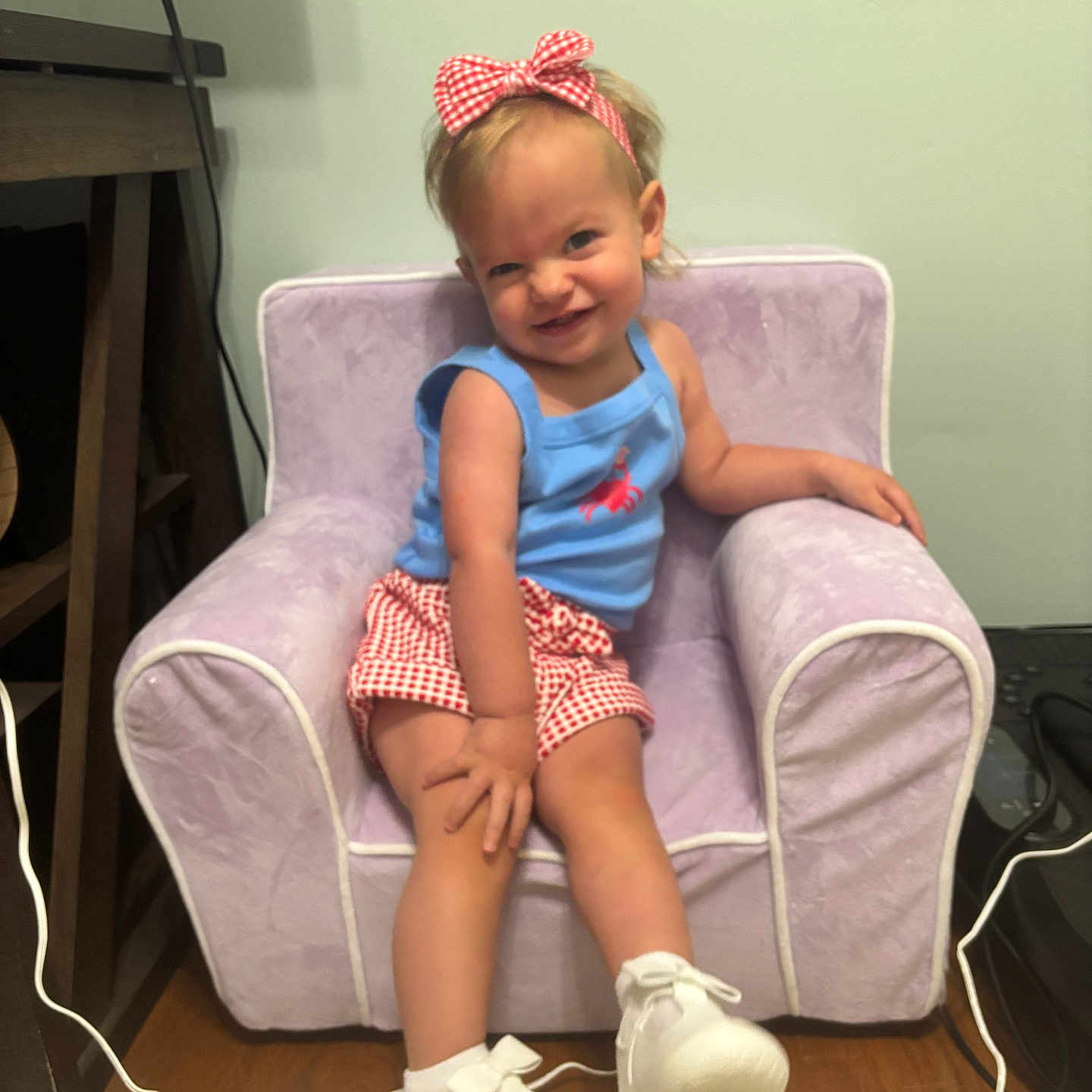 Scarlett Drew is registered to the contest to win money with this photo: toddler, child, smiling, indoor, chair, armchair, headband, clothing, footwear, carpet, furniture, person, happy, cute, red, blue, white, plush, portrait, casual