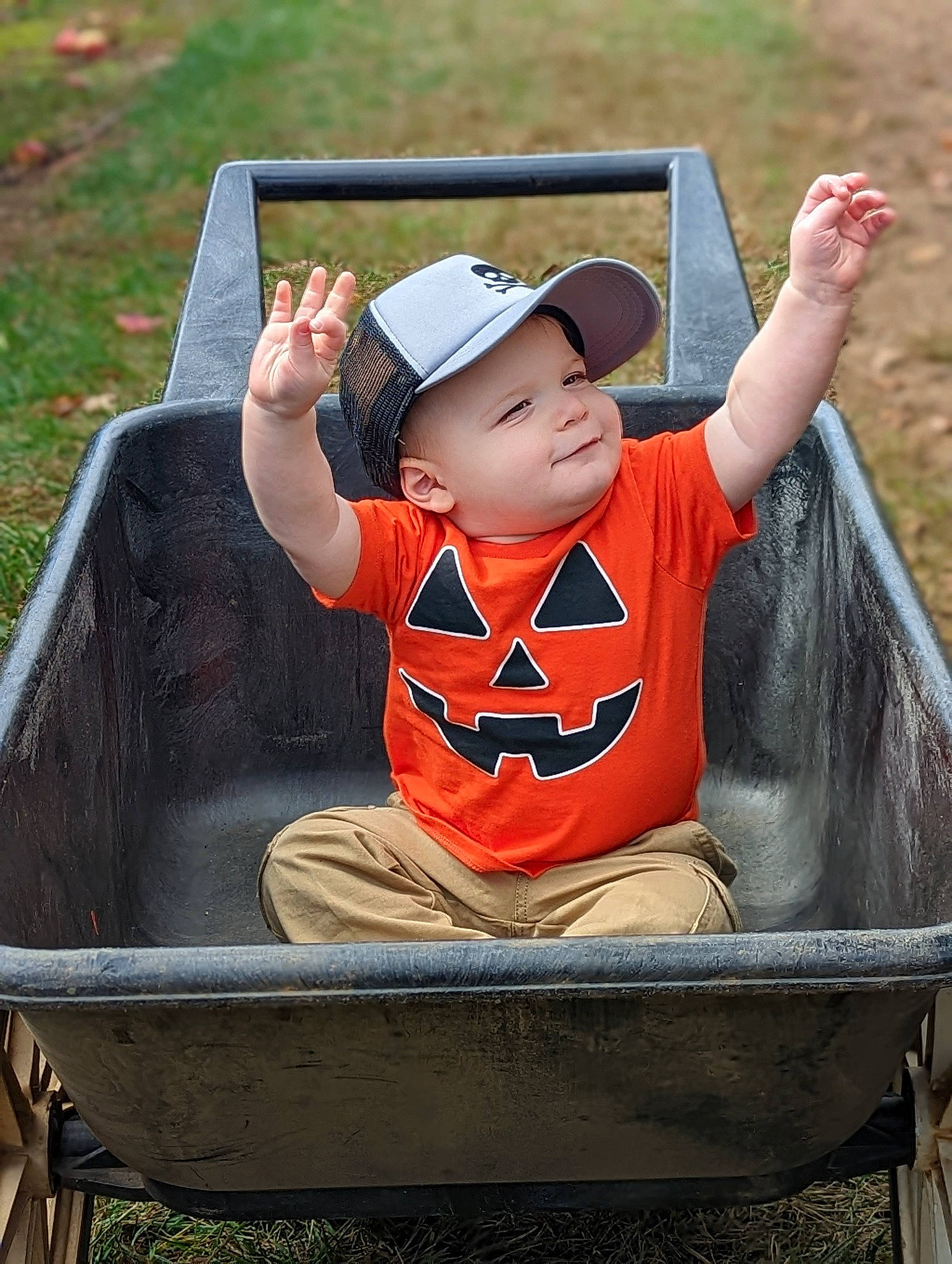 Drew is registered to the contest to win money with this photo: baby, baby_toddler_clothing, baseball_cap, cap, carmine, child, fashion_accessory, fun, grass, hand, happy, hat, headwear, leisure, person, product, recreation, sitting, smile, t_shirt