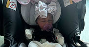 Valentina Jade. is registered to the contest to win money with this photo: baby, baby_girl, black, blanket, bow, car_seat, child, clothing, cozy, cute, indoor, infant, newborn, pacifier, person, pink, resting, safety_harness, sleeping, white