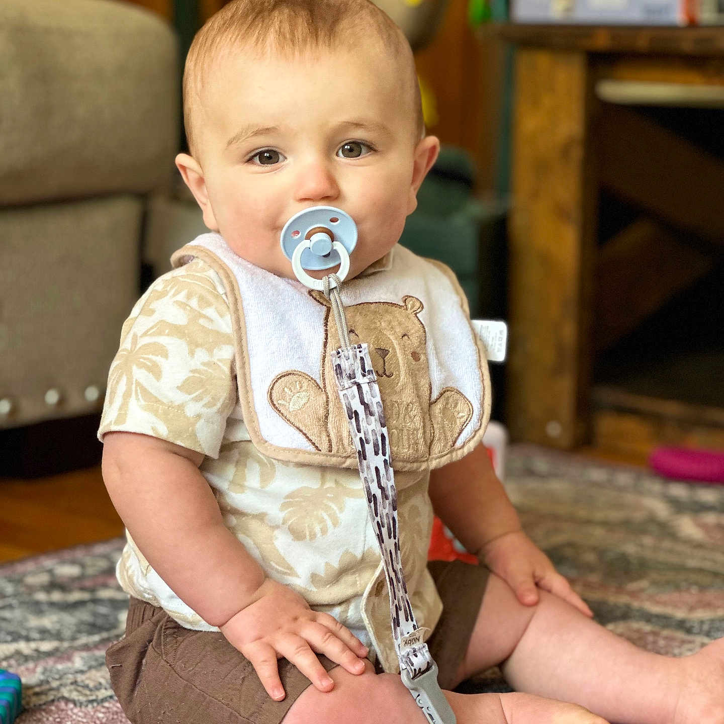 Edward is registered to the contest to win money with this photo: architecture, baby, building, clothing, couch, cutlery, dress, face, furniture, head, indoors, interiordesign, pants, person, photography, portrait, shorts, sitting, spoon, wood