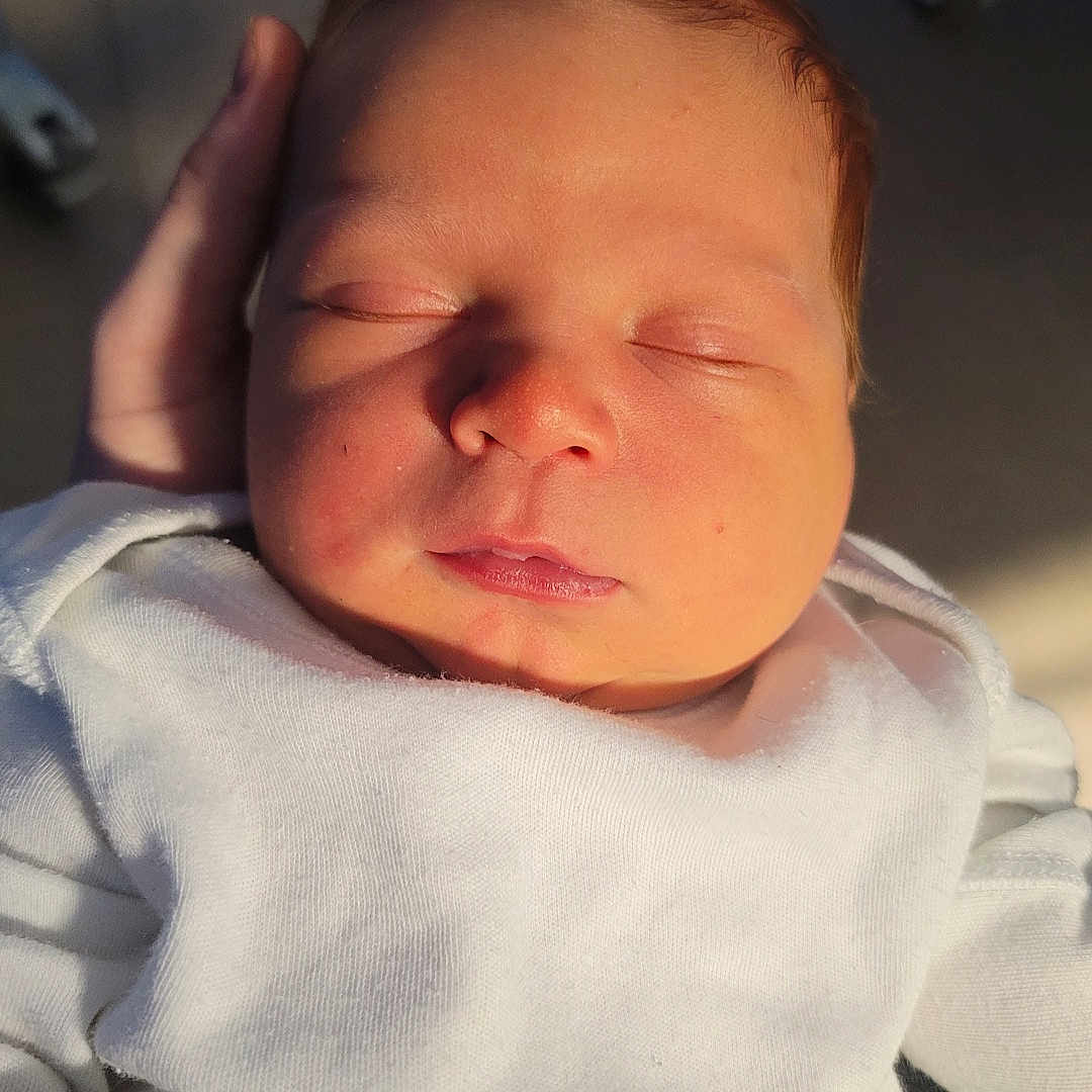 Rhydian-Cole joined the competition — help win amazing prizes! baby, calm, child, closeup, cute, face, hand, human, indoors, infant, newborn, peaceful, person, portrait, rest, skin, sleeping, soft_light, warm_light, white_clothing