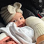 baby, child, smiling, hat, knitted_hat, bow, car_seat, blanket, winter_clothing, warm, cozy, cute, white_clothing, pink_clothing, infant, face, happy, indoors, person, portrait