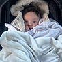 Rym participe au concours pour gagner de l'argent avec cette photo : baby, infant, blanket, car_seat, hood, fur_trim, wrapped, cozy, cute, face, person, child, clothing, sleeping_bag, soft, warm, indoors, newborn, portrait, bundle