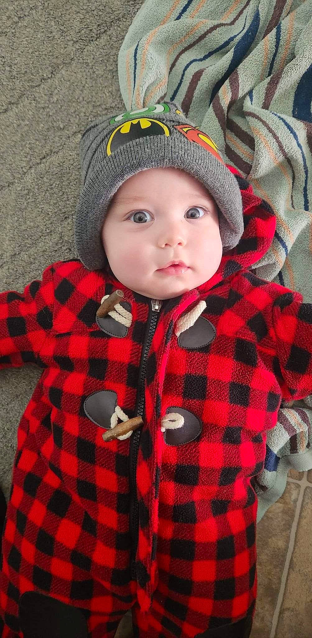 Emerson is registered to the contest to win money with this photo: baby_toddler_clothing, cap, cheek, collar, eye, face, fashion, head, headgear, headwear, lip, organ, outerwear, pattern, person, plaid, plant, sleeve, tartan, textile
