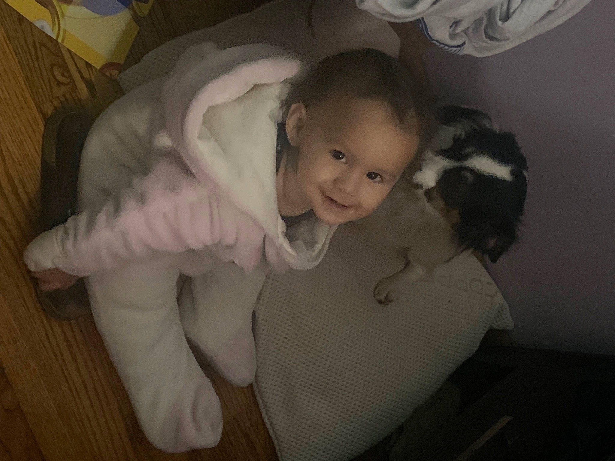 Isabella is registered to the contest to win money with this photo: arm, black_hair, child, comfort, companion_dog, ear, elbow, flash_photography, flooring, fur, gesture, happy, joy, long_hair, nose, person, room, sitting, skin, smile