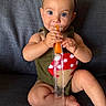 Camila joined the competition — help win amazing prizes! baby, blue_eyes, bow, child, couch, cute, face, foot, frozen_treat, green_clothing, hand, headband, indoors, infant, mushroom_design, orange_popsicle, portrait, sitting, snack, texture