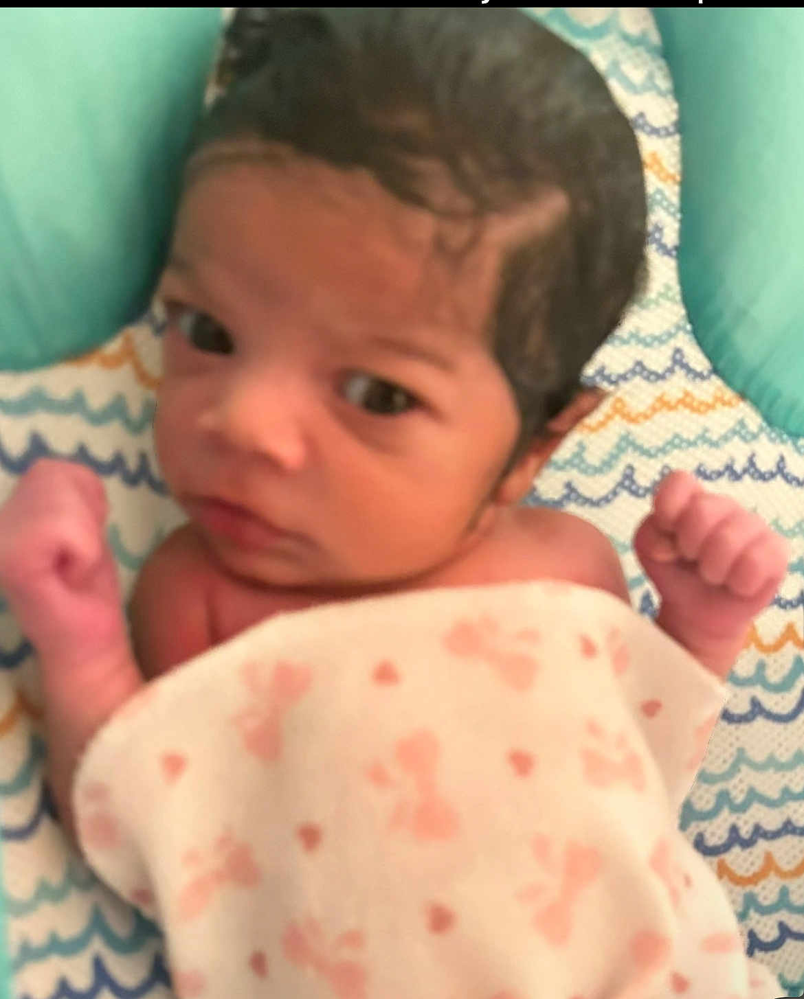 Adaijah joined the competition — help win amazing prizes! baby, newborn, infant, blanket, cushion, pattern, fist, closeup, face, skin, hair, child, indoors, resting, lying_down, soft, pink, blue, white, cute
