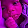 Adaijah is registered to the contest to win money with this photo: baby, newborn, closeup, face, hand, blanket, purple_light, sleepy, infant, soft, wrapped, cute, skin, person, indoors, portrait, cozy, young, expression, resting