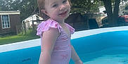 Lakelynn is registered to the contest to win money with this photo: child, toddler, swimsuit, pool, water, outdoor, backyard, trees, grass, play, summer, smile, happy, ripple, daylight, nature, fun, person, pink, blue