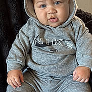 Camryn joined the competition — help win amazing prizes! baby, blue_eyes, casual_wear, child, comfortable, cozy, curious_expression, cute, face, gray_clothing, hands, hoodie, indoor, infant, nike_logo, portrait, sitting, soft_blanket, white_socks, young_child