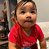 baby, child, couch, curious, cute, expression, eyes, face, flowers, furniture, hair, hands, home, indoors, person, portrait, red_shirt, sitting, skin, toddler