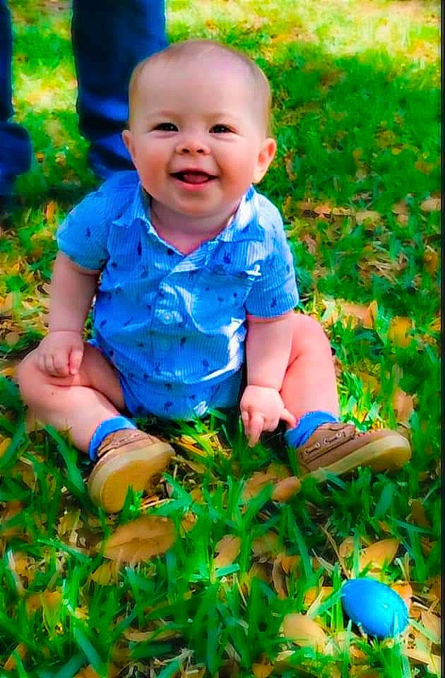 River is registered to the contest to win money with this photo: adaptation, baby, baby_laughing, baby_toddler_clothing, blue, botany, clothing, grass, green, groundcover, happy, joy, leaf, light, nature, people_in_nature, person, photograph, plant, smile
