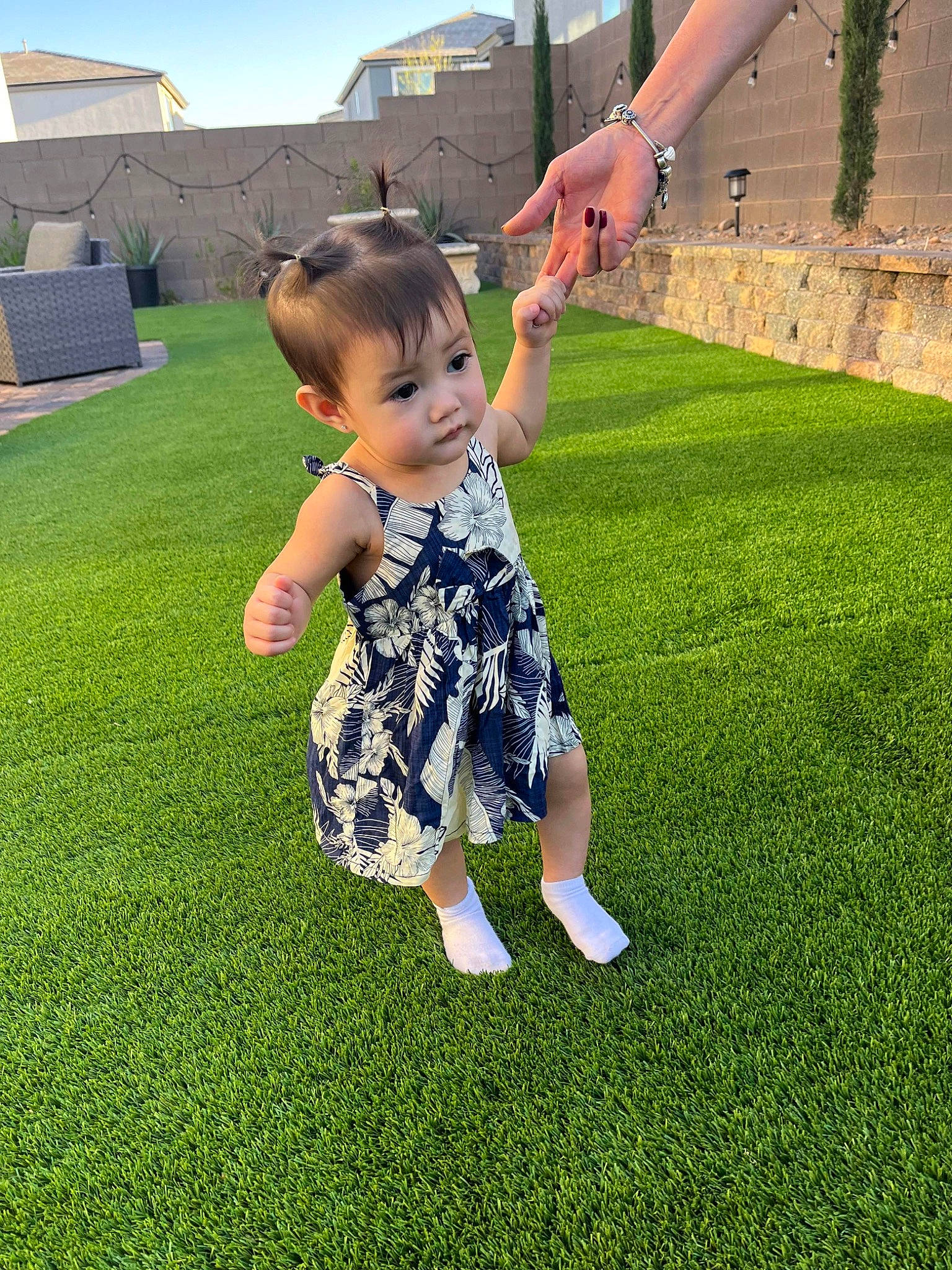 Ariella is registered to the contest to win money with this photo: baby_toddler_clothing, flooring, fun, gesture, grass, grass_family, grassland, happy, human_leg, lawn, leg, leisure, meadow, people_in_nature, person, plant, recreation, sky, summer, t_shirt