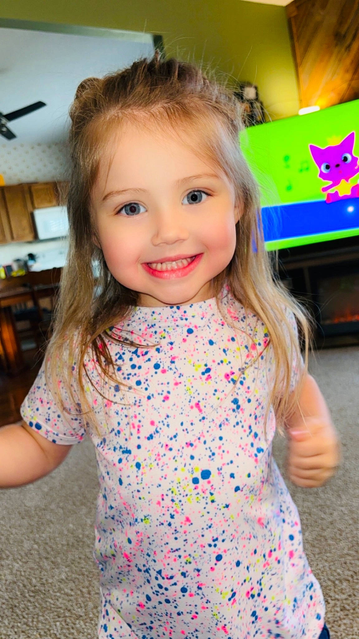 Harper is registered to the contest to win money with this photo: baby_toddler_clothing, beauty, ceiling_fan, electric_blue, eyelash, facial_expression, fun, hair, hairstyle, happy, iris, joy, leisure, mechanical_fan, person, skin, sleeve, smile, standing, t_shirt