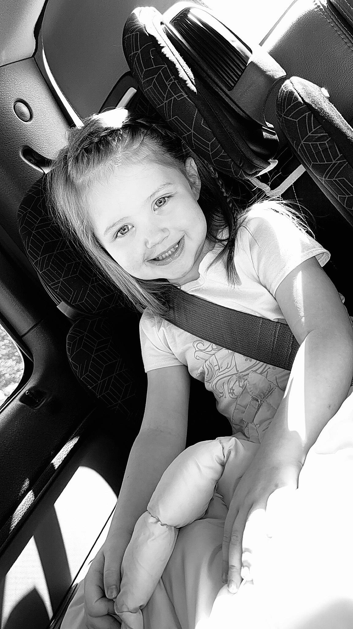 Harper joined the competition — help win amazing prizes! automotive_design, black, black_and_white, car_seat, car_seat_cover, child, comfort, flash_photography, gesture, happy, human_leg, joy, monochrome, monochrome_photography, motor_vehicle, person, smile, steering_wheel, style, thigh