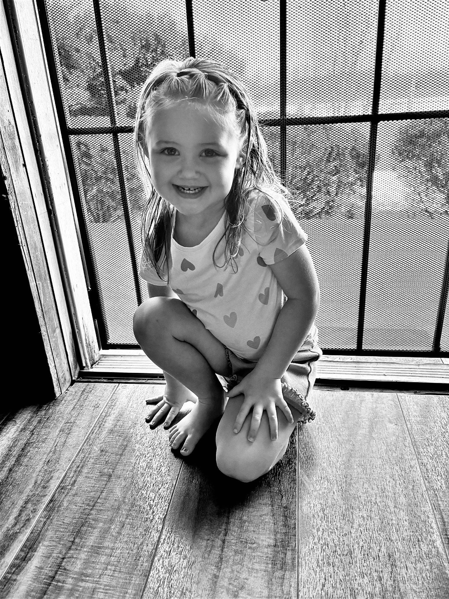 Harper is registered to the contest to win money with this photo: baby, barefoot, black_and_white, child, fence, flooring, foot, fun, happy, human_leg, joy, knee, mesh, monochrome, monochrome_photography, person, smile, standing, style, thigh