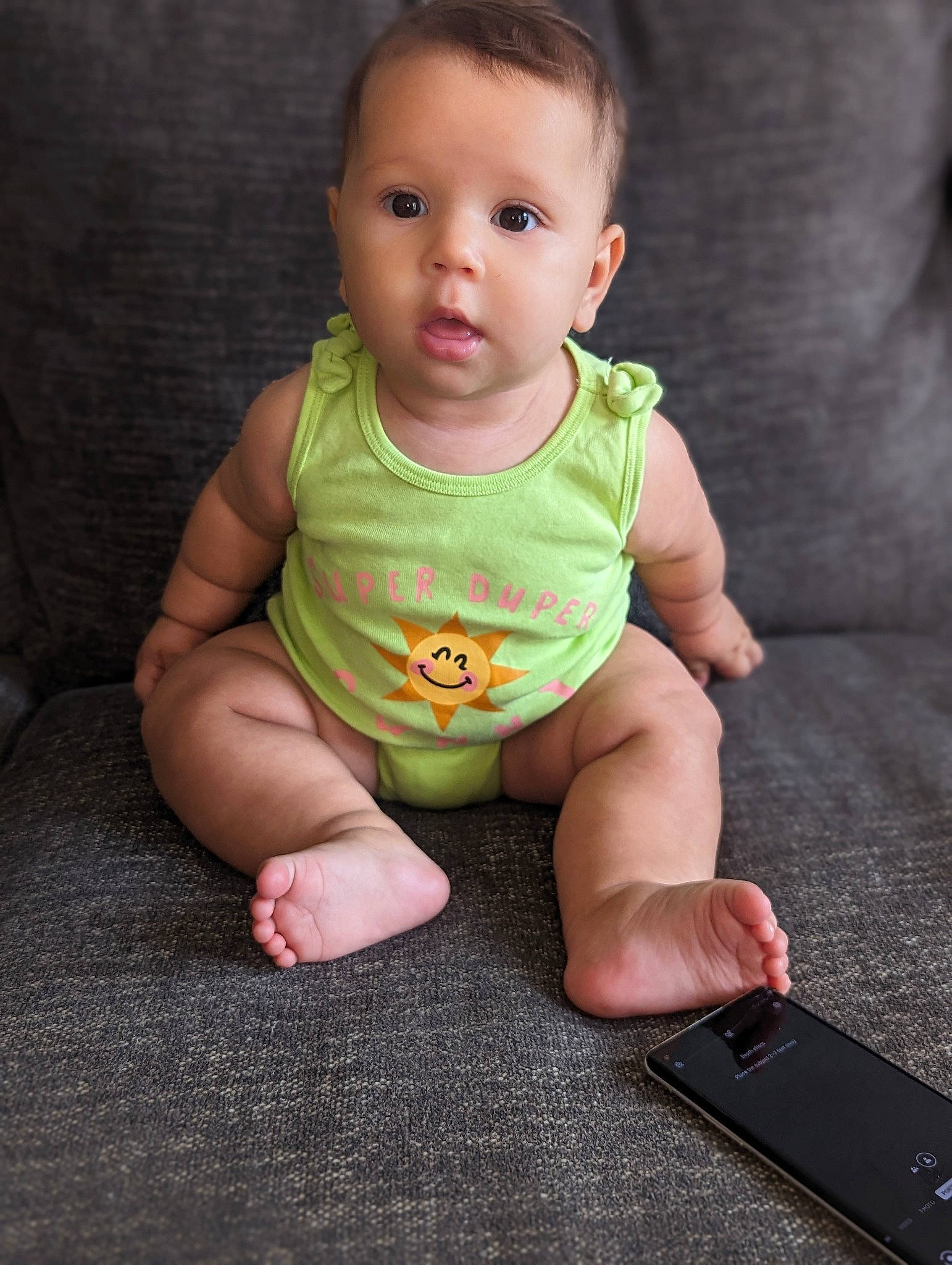 Camila is registered to the contest to win money with this photo: baby, baby_toddler_clothing, beauty, cheek, child, comfort, communication_device, face, finger, floor, flooring, foot, gadget, iris, leg, mobile_phone, nose, person, skin, sleeve