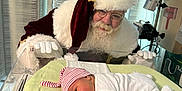 Daysha joined the competition — help win amazing prizes! baby, newborn, hospital, incubator, santa_claus, pacifier, hat, blanket, white_clothing, glasses, beard, curtains, medical_equipment, smile, portrait, infant, holiday, christmas, person, gloves