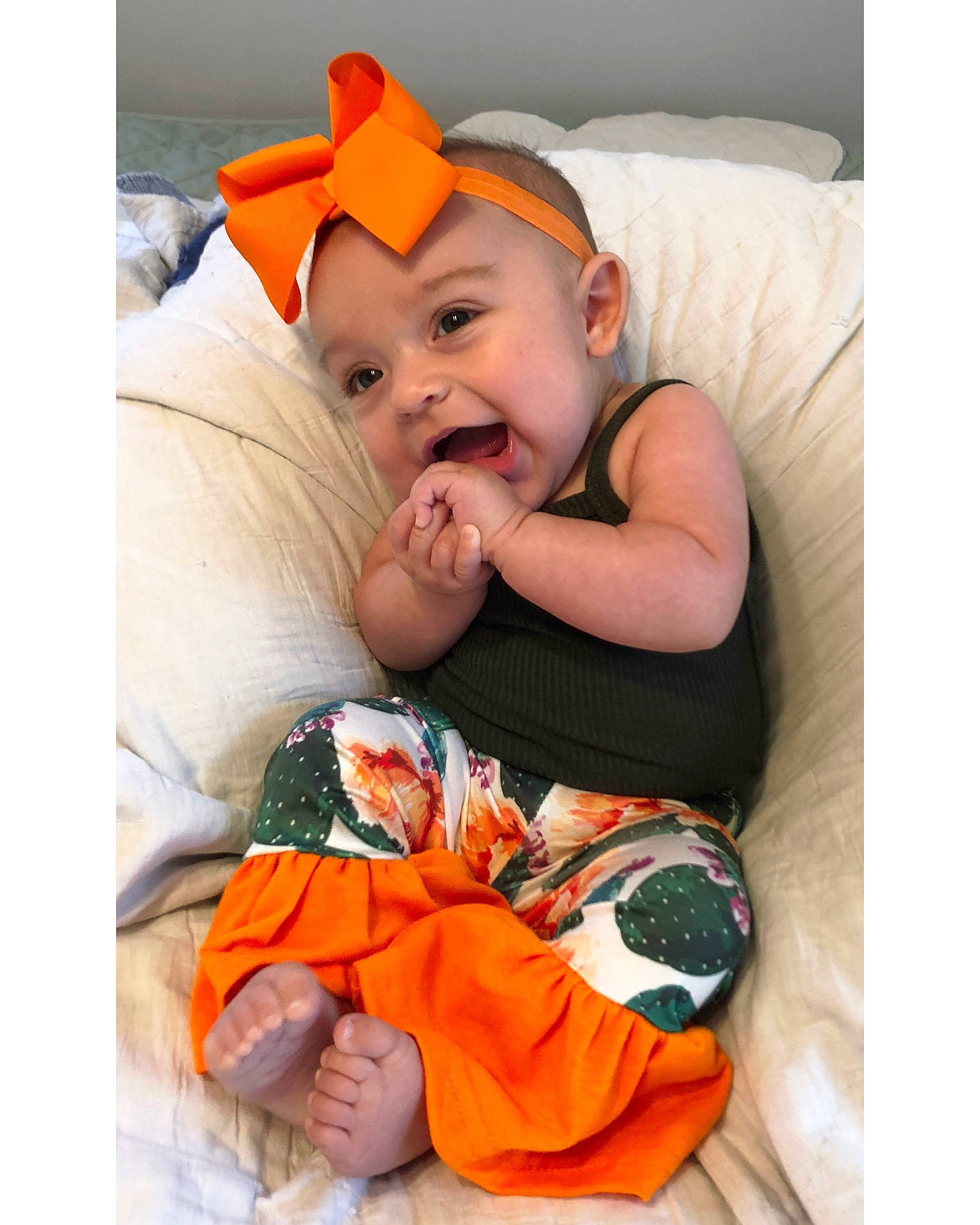 Brogan is registered to the contest to win money with this photo: baby, baby_products, baby_toddler_clothing, bedding, blanket, bonnet, child, comfort, finger, foot, headband, headwear, linens, nail, nose, orange, person, toddler, tongue