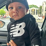 Jaheim joined the competition — help win amazing prizes! toddler, child, baby, black_clothing, hoodie, knit_hat, new_balance_logo, hand, car_interior, window, rain, urban, building, person, face, eyes, portrait, expression, support, casual
