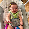 Luna joined the competition — help win amazing prizes! baby, child, smiling, sitting, baby_seat, toy, pony_toy, green_clothing, hair_clip, happy, indoor, wooden_floor, harness, infant, cute, face, hand, colorful, childrens_toy, home