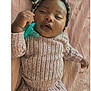 Heiress is registered to the contest to win money with this photo: baby, infant, pacifier, bow, headband, knitwear, blanket, sleeping, cozy, cute, child, person, soft, pink, relaxing, hand, face, portrait, indoors, resting