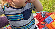 black_shorts, blonde_hair, casual, child, curious, cute, grass, nature, outdoor, patchwork, person, picnic, quilt, ripped_jeans, striped_shirt, summer, sunlight, thumb_sucking, toddler, yellow_socks