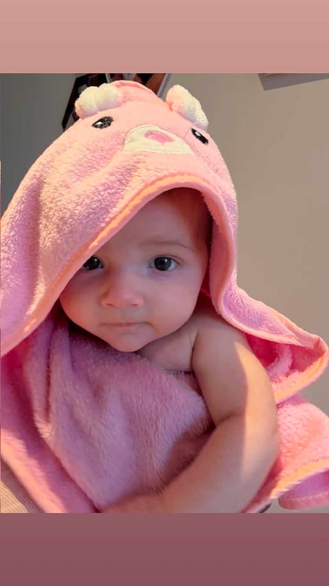 Athena is registered to the contest to win money with this photo: baby, child, pink_towel, hood, cute, portrait, indoor, face, infant, soft_texture, wrapped, looking, young_child, adorable, skin, person, towel, expression, closeup, calm